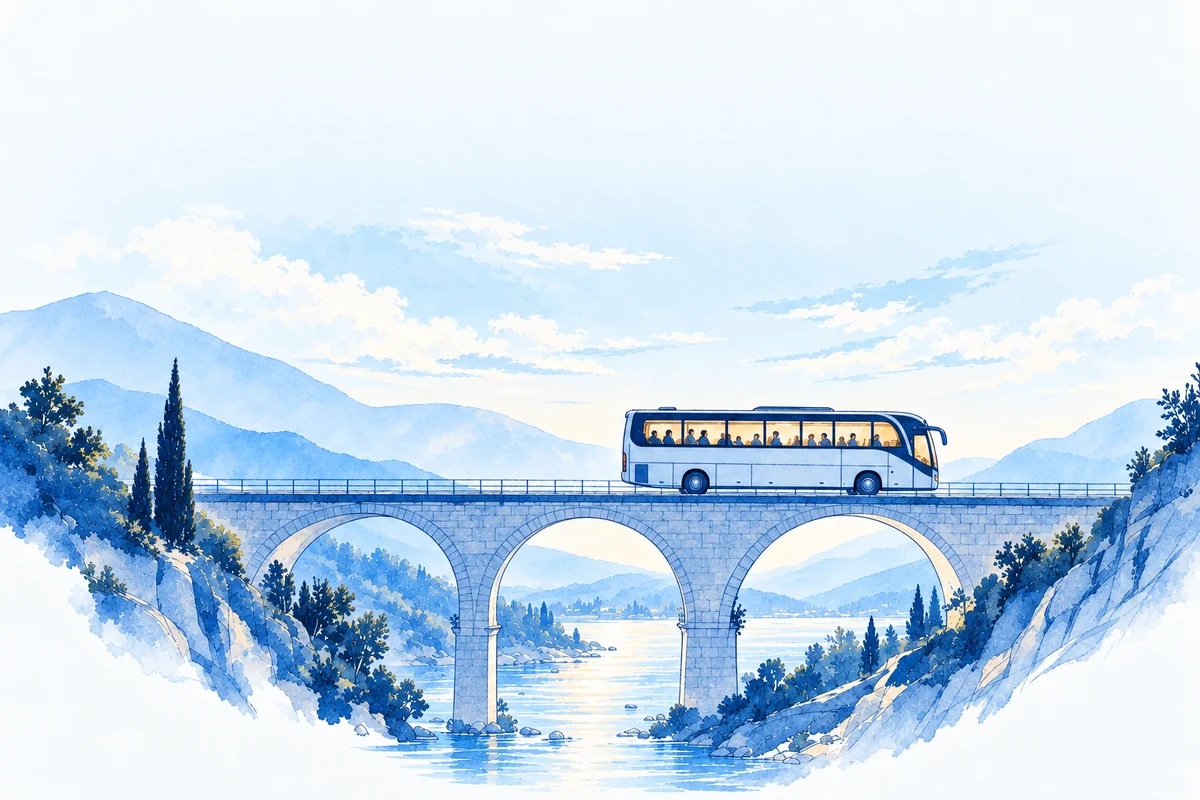 A lone coach crosses a stone viaduct through dusk-blue hills, its windows lit, a river winding below